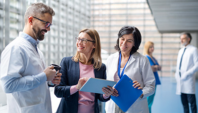 Group of people looking at papers and talking with each other.