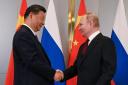 Russian President Vladimir Putin, right, and Chinese President Xi Jinping shake hands during their meeting on the side-lines of the Shanghai Co-operation (Sergey Guneyev, Sputnik, Kremlin Pool Photo via AP)