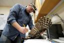 A wildlife technician checks a culled barred owl (AP Photo/Ted S. Warren, File)