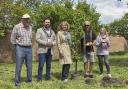 A pear tree was planted in The Grange’s orchard by shoemaker Howard Burch and Angela Southern (right of the tree).