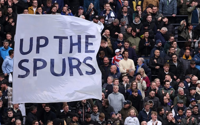 Tottenham fans hold up a flag saying 'Up the Spurs' during the Premier League match against Arsenal on April 28, 2024