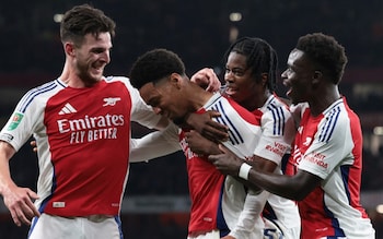 Ethan Nwaneri is mobbed by his Arsenal team-mates after scoring