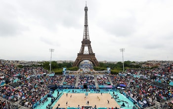 A view of the beach volleyball pool matches at the Paris Olympics with the Eiffel Tower in the background