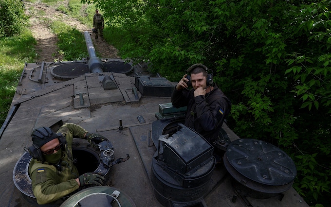 Ukrainian servicemen of the 21st Separate Mechanized Brigade ride a Leopard 2A6 tank, amid Russia's attack on Ukraine, near a front line in Donetsk region, Ukraine May 12, 2024. REUTERS/Valentyn Ogirenko