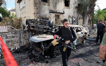 A member of the Israeli security forces stands guard inside a cordoned-off area in Kiryat Bialik in the Haifa district of Israel