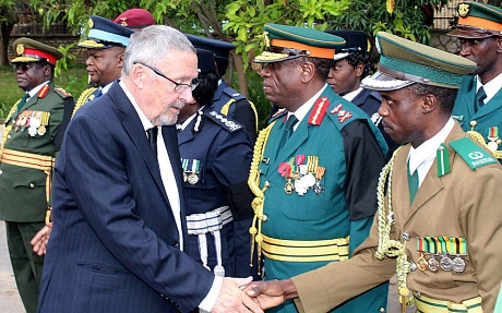 Guy Scott, left, greets defence and security chiefs shortly after taking over as acting President in Lusaka