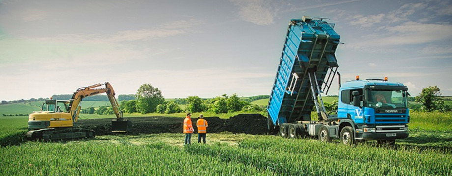 Trucks spreading fertiliser in a field