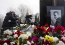 Lyudmila Navalnaya, the mother of Russian opposition leader Alexei Navalny, is embraced as she visit his grave