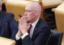 First Minister John Swinney pictured in the Scottish Parliament chamber