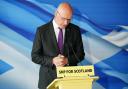 John Swinney pictured at a press conference in Edinburgh