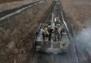 Russian Army soldiers ride their armoured toward positions at an undisclosed location in Ukraine