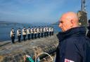 Labour's Defence Secretary John Healey surveys a UK nuclear submarine as it returns from extended patrol