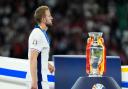 England striker Harry Kane walks past the Euro 2024 championship trophy