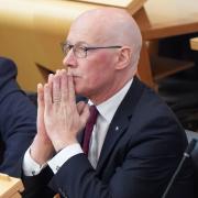 First Minister John Swinney pictured in the Scottish Parliament chamber