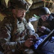 Ukrainian serviceman Andrii, left, of the  Air Assault Forces 148th separate artillery brigade,  sends receiving coordinates for a Furia drone at the frontline in Donetsk region, Ukraine
