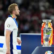 England striker Harry Kane walks past the Euro 2024 championship trophy