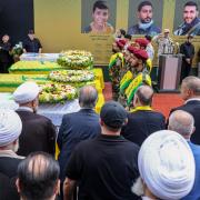 Hezbollah fighters and mourners attend a funeral of people killed after hundreds of paging devices exploded in a deadly wave across Lebanon