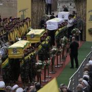 Hezbollah fighters carry the coffins of fallen four comrades who were killed Tuesday after their handheld pagers exploded