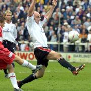 Darlington striker Barry Conlon attempts to block a clearance during Quakers' last match at Feethams in May 2003