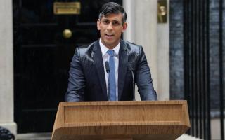 Rishi Sunak in the rain outside Downing Street.