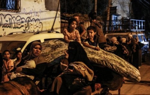 Displaced families flee from the east of Bureij in central Gaza. 