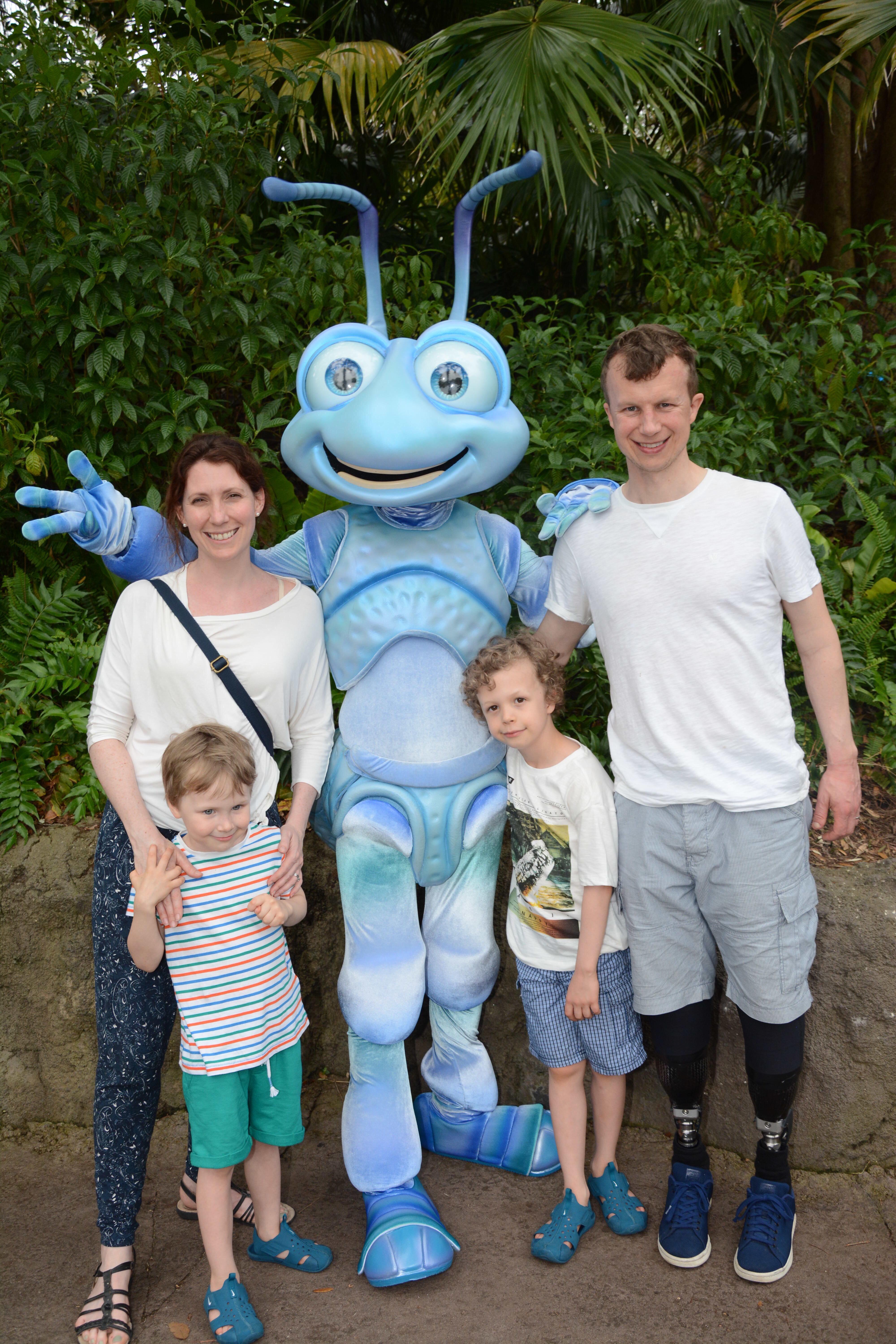  Hannah and Philip pose for a fun family snap with their kids and a Bugs Life star