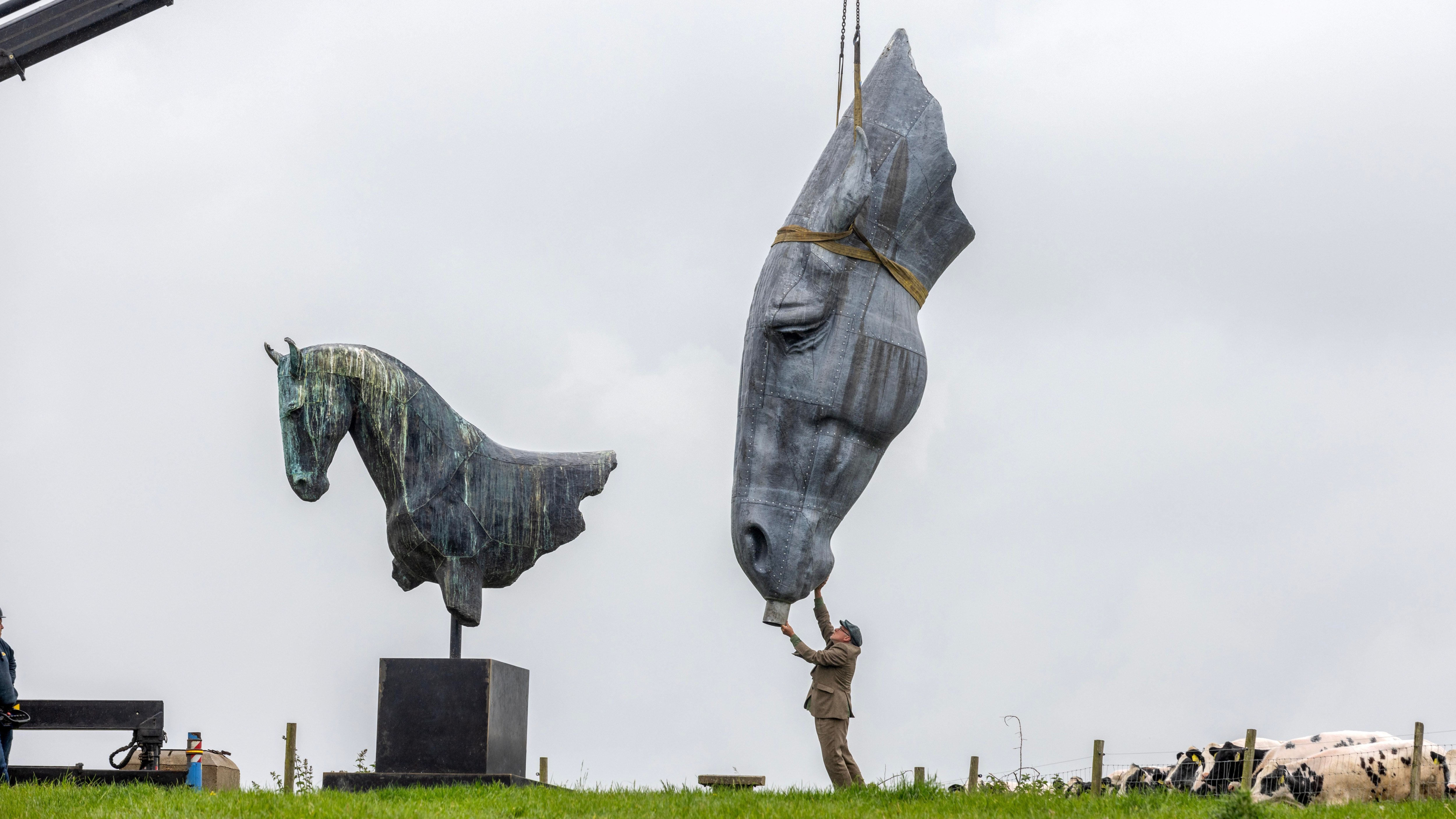 The sculptor Nic Fiddian-Green guides his one-and-a-half ton lead sculpture of a horse head onto its plinth on a hill near Oxshott in Surrey. The sculpture, entitled Serenity, will replace Fiddian-Green’s older sculpture, Roman Horse, and will be able to be seen by motorists on the A3