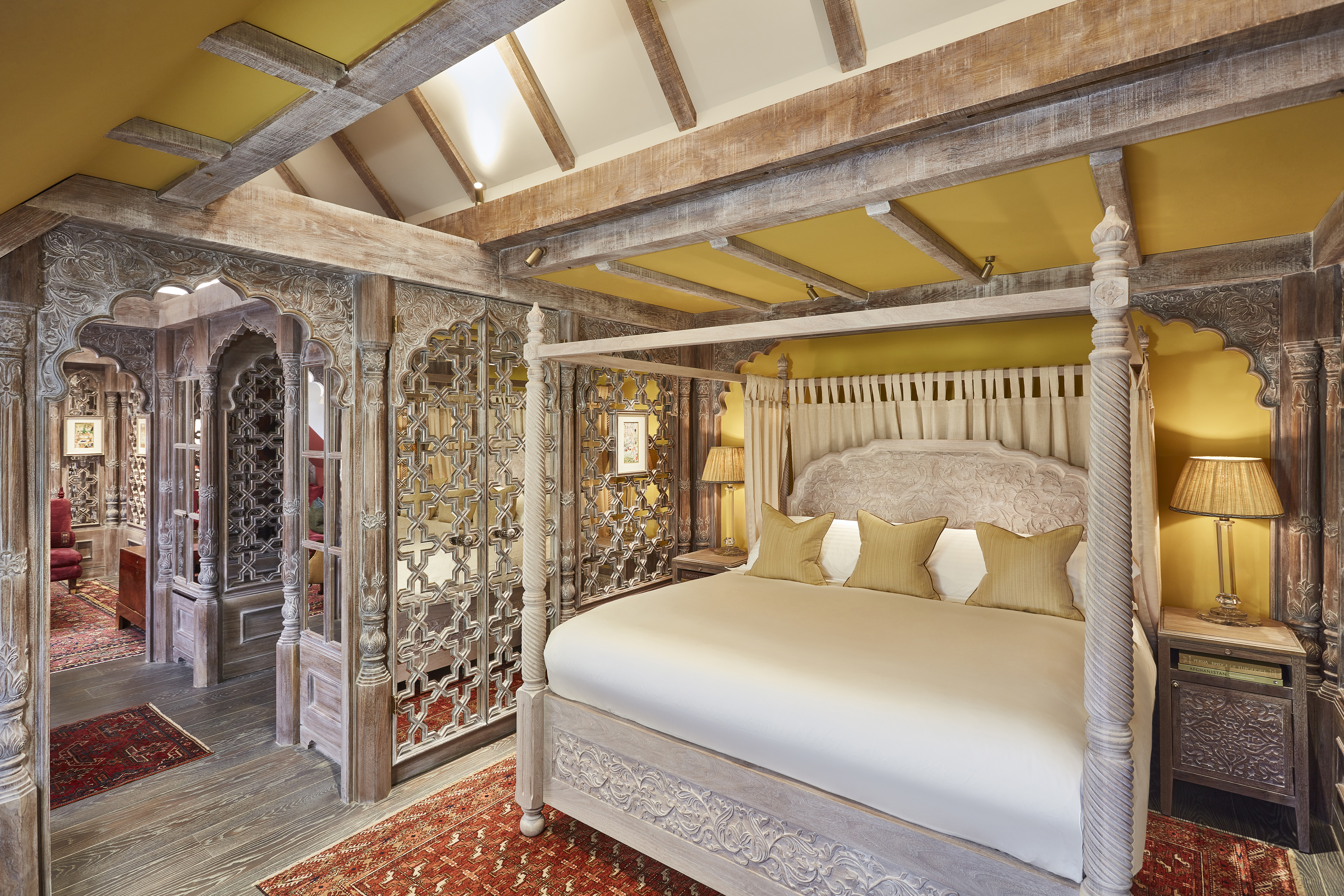 The suite comes with a carved four-poster bed