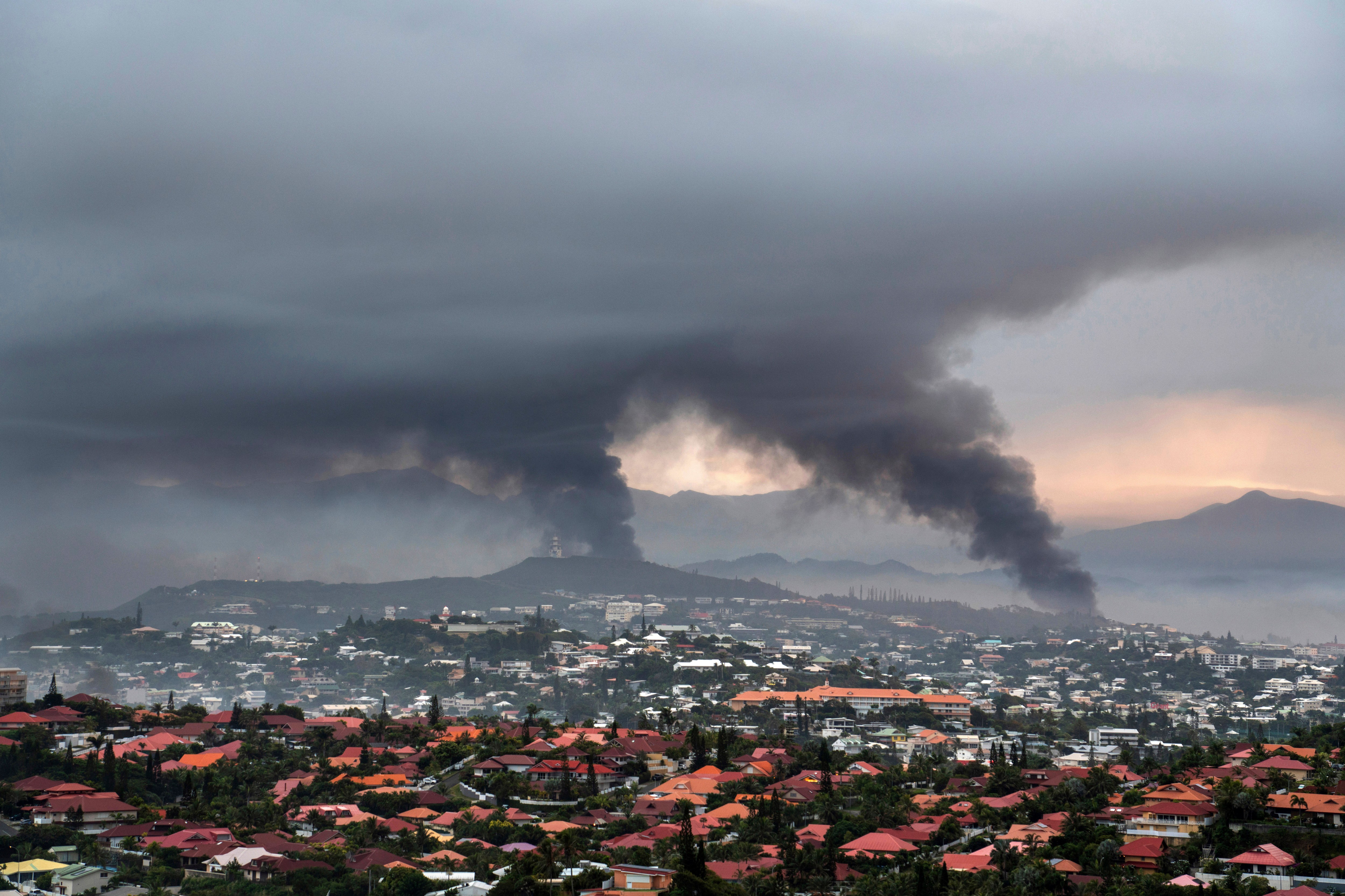 Smoke rises in Nouméa during protests earlier this month