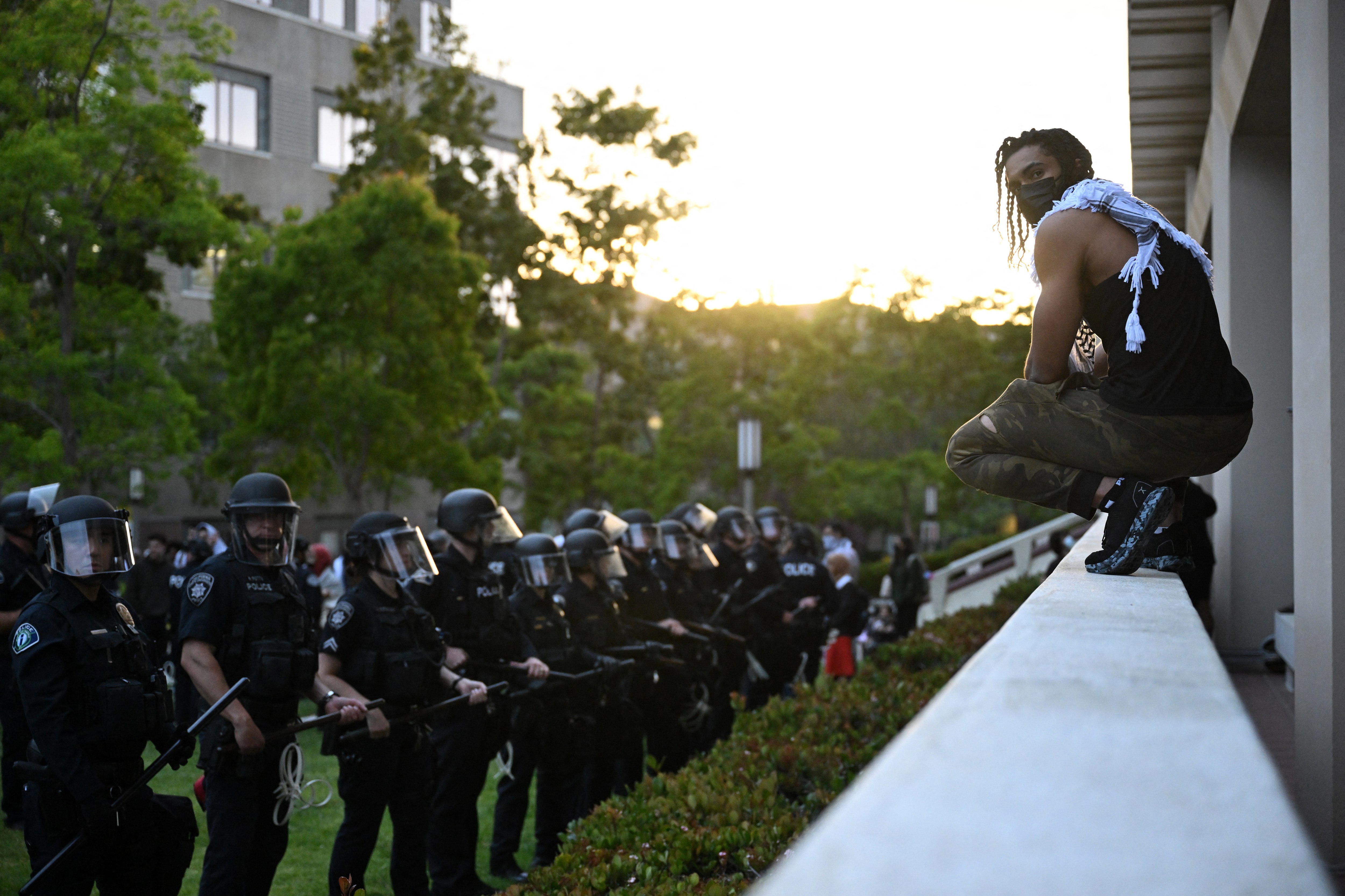 A pro-Palestinian demonstrator confronts police as they clear an encampment at the University of California, Irvine