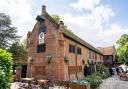 A historic Tudor pub surrounded by a moat and landscaped gardens is a popular spot for weddings, with “breathtaking backdrops” for photographs.