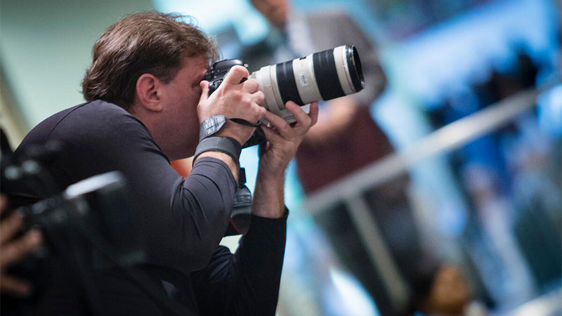 UN photographer Evan Schneider covering a press encounter outside the Security Council Chamber at UN headquarters.