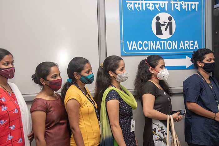 women with face masks waiting in line