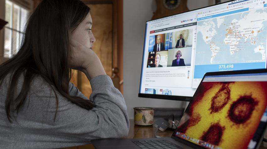 Young woman follows the virtual briefing on screen.