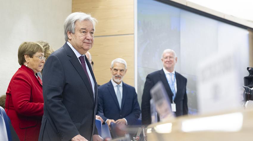 Secretary-General António Guterres standing at podium with other UN officials behind him.