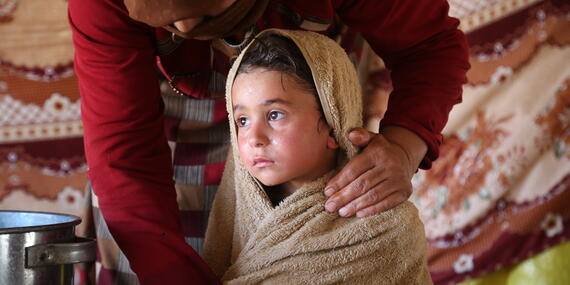 Five-year-old Moaz Al-Hammoud is wrapped in a wet towel to help him cope with the scorching heat in Syria. Moaz lives with his family in the Al-Hamra camp in North-West Syria’s Idleb.