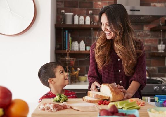 A woman and a boy preparing a lunch