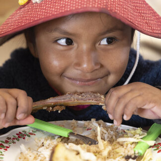 Indigenous Uru girl enjoying a healthy meal