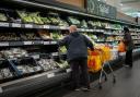 Shoppers in the fruit and vegetables section of a branch of Sainsbury's in south London. Shoppers are said to be buying a raft of Christmas items, such as presents and frozen turkeys, early in a bid to make sure their festive celebrations are not