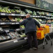 Shoppers in the fruit and vegetables section of a branch of Sainsbury's in south London. Shoppers are said to be buying a raft of Christmas items, such as presents and frozen turkeys, early in a bid to make sure their festive celebrations are not