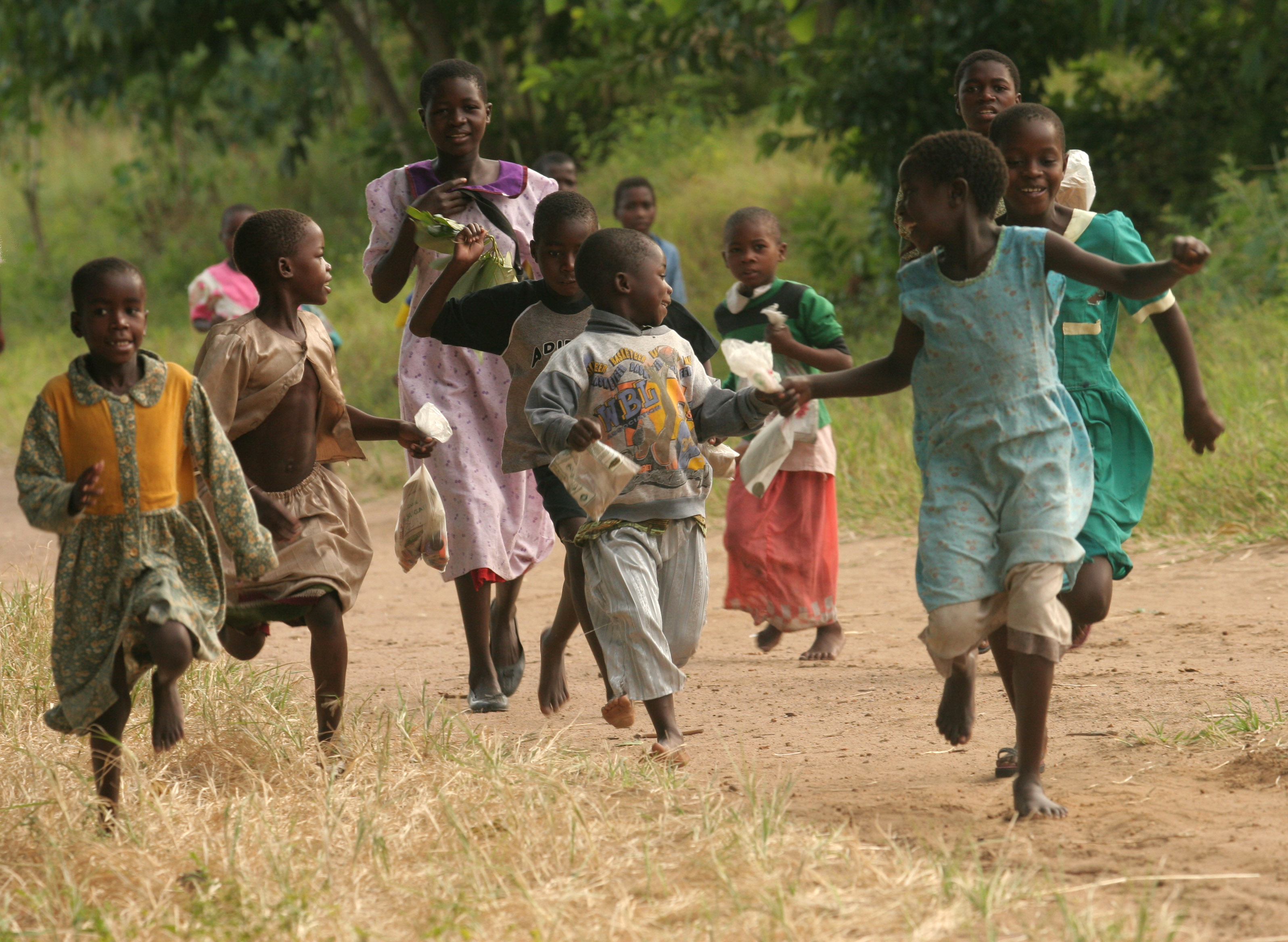 group of children running in countryside