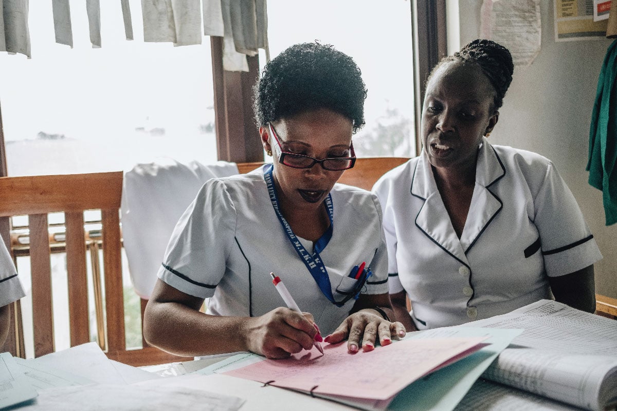 Two Kenyan nurses filling forms