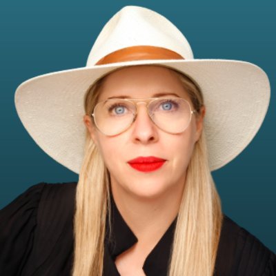 Headshot of Tiffay Shlain wearing white hat on teal background.