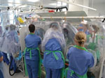 Thumbnail of Isolator–isolator transfer is the safest means of transfer for patients with serious infectious diseases and requires practice in dedicated training exercises, as shown.