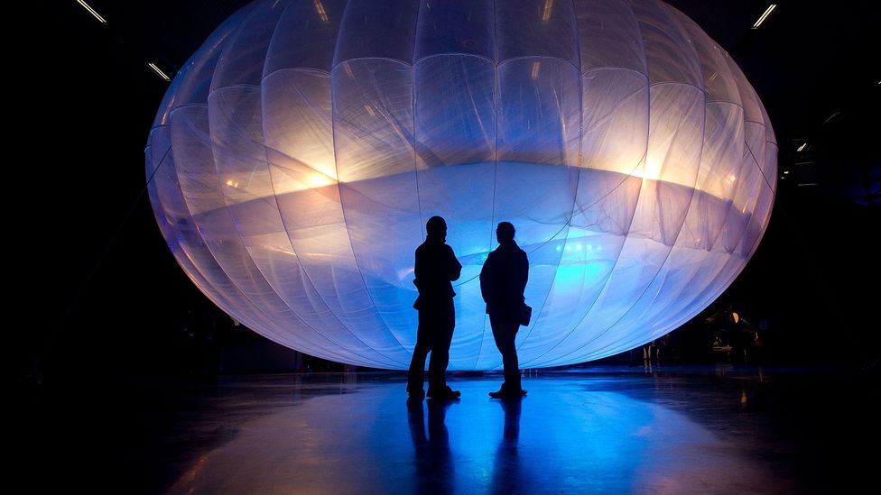 Two figures silhouetted in front of Loon design (Credit: Marty Melville/AFP/Getty Images)