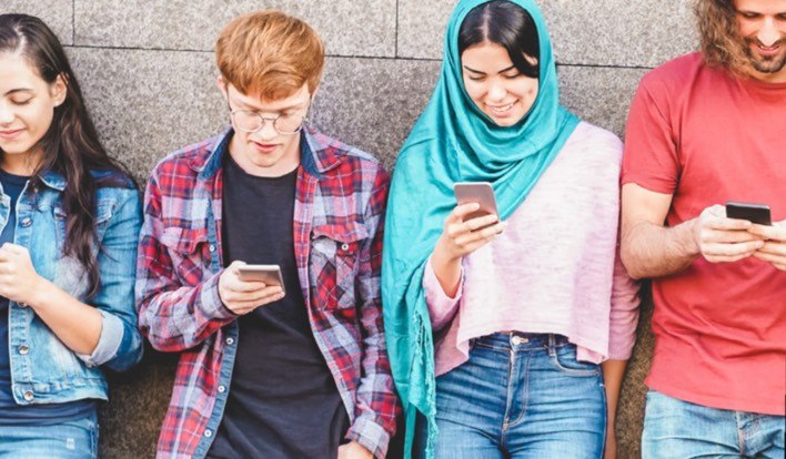 group of friends looking at their phones