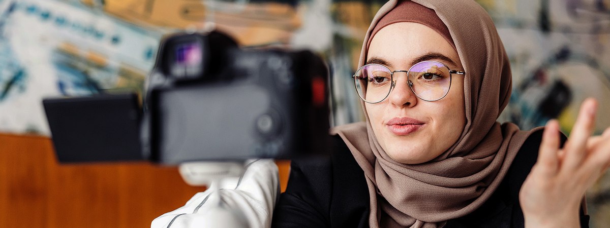 A young woman creating content using her personal video camera