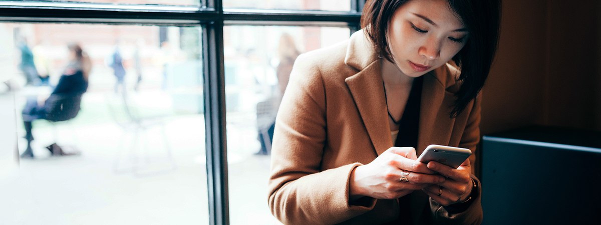 A woman surfing the Internet on her mobile phone