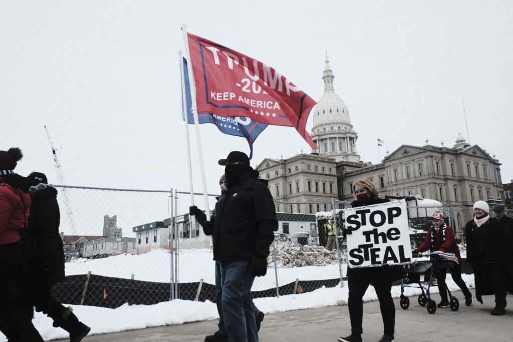 LANSING, MI - JANUARY 06: Donald Trump Supporters march around the Michigan State Capitol Building to protest the certification of Joe Biden as the next president of the United States on January 6, 2021 in Lansing, Michigan. Trump supporters gathered at state capitals across the country to protest today's ratification of President-elect Joe Biden's Electoral College victory over President Trump in the 2020 election. (Photo by Matthew Hatcher/Getty Images)
