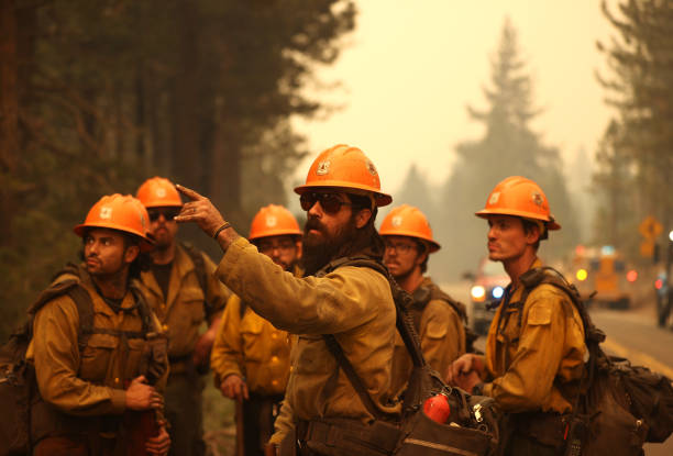 MEYERS, CALIFORNIA - AUGUST 31: U.S. Forest Service firefighters prepare to battle the Caldor Fire on August 31, 2021 in Meyers, California. The Caldor Fire has burned over 190,000 acres, destroyed hundreds of structures and is currently 16 percent contained. (Photo by Justin Sullivan/Getty Images)